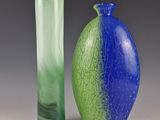 two vases sitting next to each other on a table