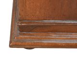 a clock that is sitting on top of a wooden table