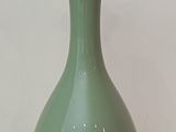 a green lamp that is on top of a glass table