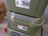 two green storage boxes stacked on top of each other