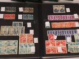 an open book with stamps on it sitting on top of a table