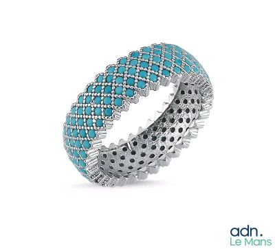 a close up of a ring with blue stones on it