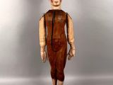 statue of a man with a bald head wearing a brown dress