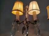 a chandelier with three lamps and a lamp shade on it