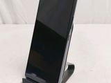 an image of a cell phone sitting on a stand on a table
