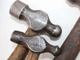 two hammers that are sitting next to each other on a table