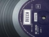 a black record with a purple label on it