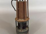 Une cafetière à l'ancienne est posée sur un plan de travail blanc.