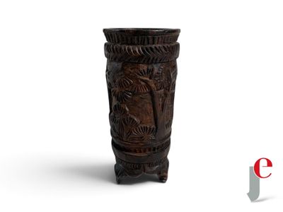a wooden vase with carvings on it on a white surface