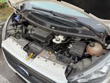 a car that has its hood open with the engine in it