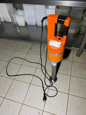 an orange machine that is sitting on a tiled floor
