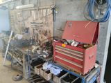 a red tool box sitting on a workbench in a garage