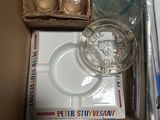 a box with a glass of water, a glass of water, a glass of water, a glass of water, and a box of cigarettes