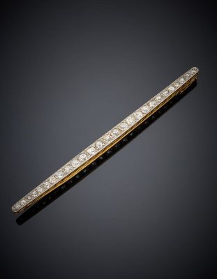 a gold and diamond bar broochle
