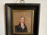 portrait of a man in a black suit and white shirt in a black frame