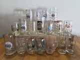 a lot of glasses sitting on a wooden table