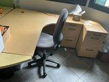 a desk with a chair and a computer on it