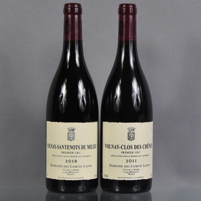two bottles of red wine sitting next to each other on a table