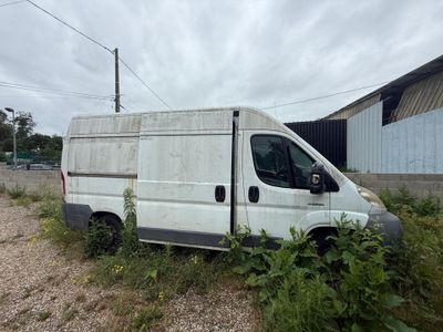 a white van that is sitting in the grass