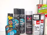 many different types of spray paint on a table