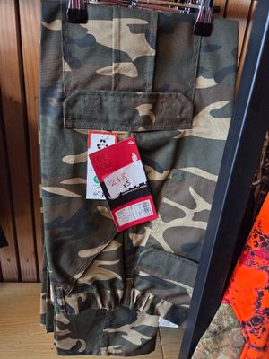 a camouflage pants hanging on a clothes rack in a store