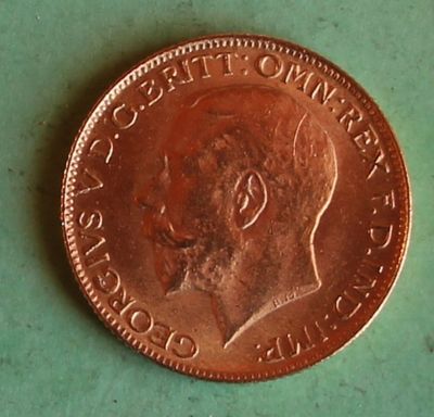 a close up of a penny on a green surface