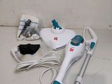 a white and blue steam mop sitting on the floor