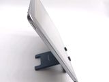 a tablet computer sitting on a stand on a white surface