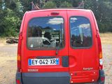 a red van that is parked in a parking lot
