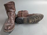 a pair of brown boots sitting on top of a table
