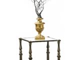 a vase that has a branch in it on a table