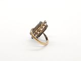 a close up of a gold ring with a diamond in it
