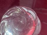a glass of water with a red liquid inside of it