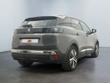the rear end of a grey suv parked in a room