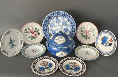 a lot of plates and bowls that are sitting on a table