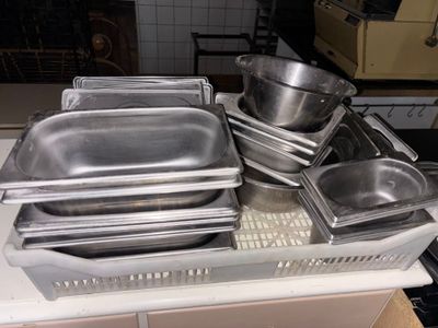 de nombreuses casseroles et poêles posées sur un plan de travail de cuisine