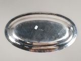 a silver plate with a diamond on it on a table