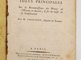 an old book with a yellow cover sitting on top of a white table
