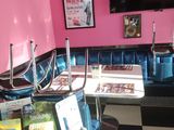 a pink and black checkered floor with a tv on the wall
