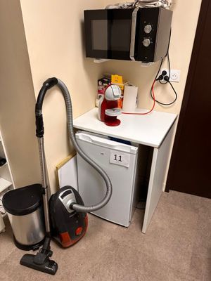 a small kitchen with a microwave, dishwasher, and a dishwasher