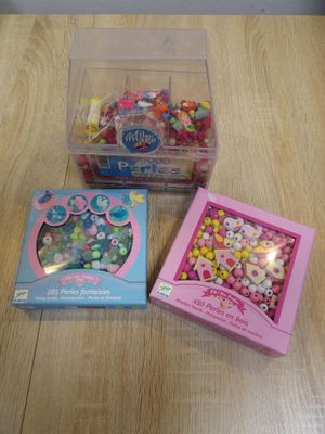 two boxes of candy and a box of beads on a table