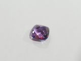 a purple amethorate stone on a white surface