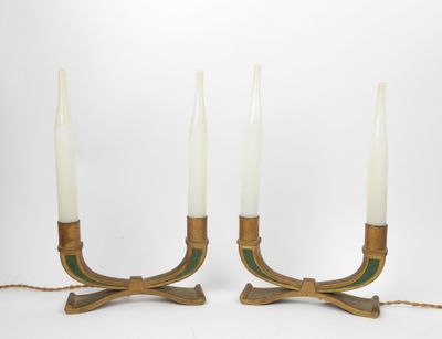 a pair of brass candles with green and white candlesticks