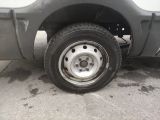 a truck with a flat tire that is parked on the side of the road