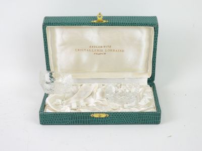 a small box with a glass figurine inside of it