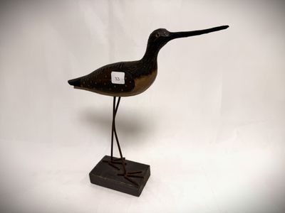 an image of a wooden bird on a stand on a white background
