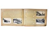 an old photo album with a picture of a train on the cover
