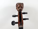 a close up of a violin with a lion head on the back of it