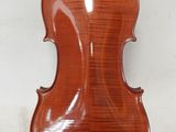 an antique violin with a wooden back and a wooden bow