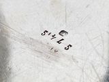 a close up of a silver plate on a table
